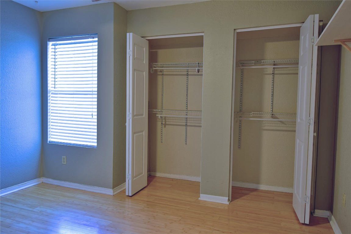 7635 Guadalupe Street, Unit 803 Austin, TX 78752 - Photo 8 of 16 an empty room with wooden floor closet and windows