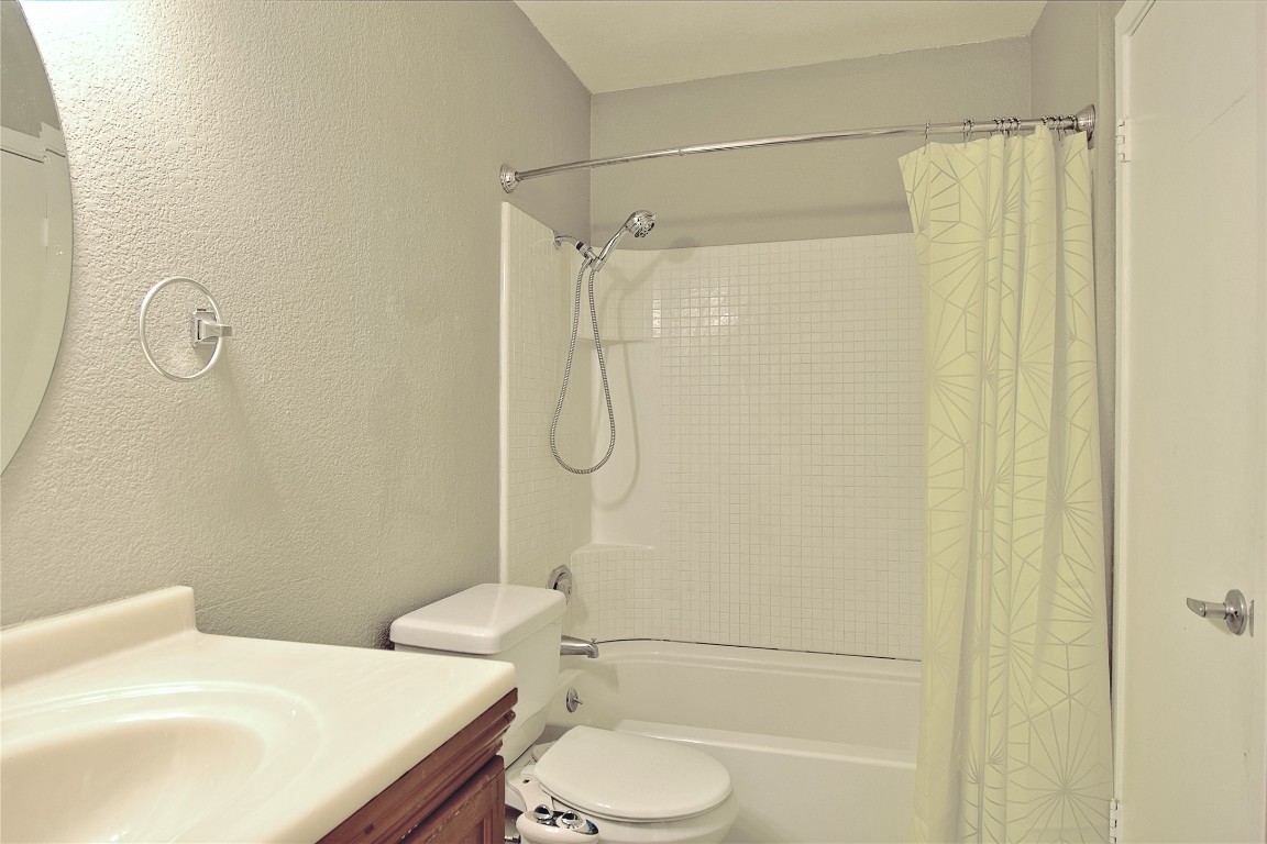 7635 Guadalupe Street, Unit 803 Austin, TX 78752 - Photo 10 of 16 a bathroom with a toilet and shower
