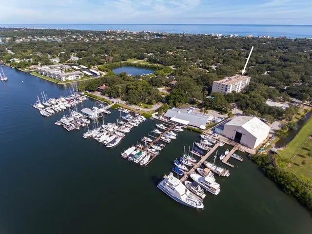 an aerial view of a house with a lake