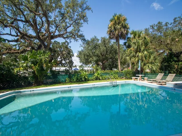 a view of a swimming pool with a yard