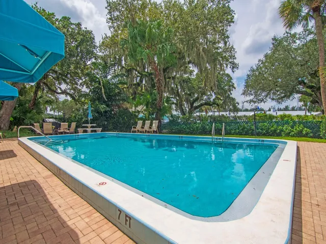 a view of swimming pool with a garden and trees