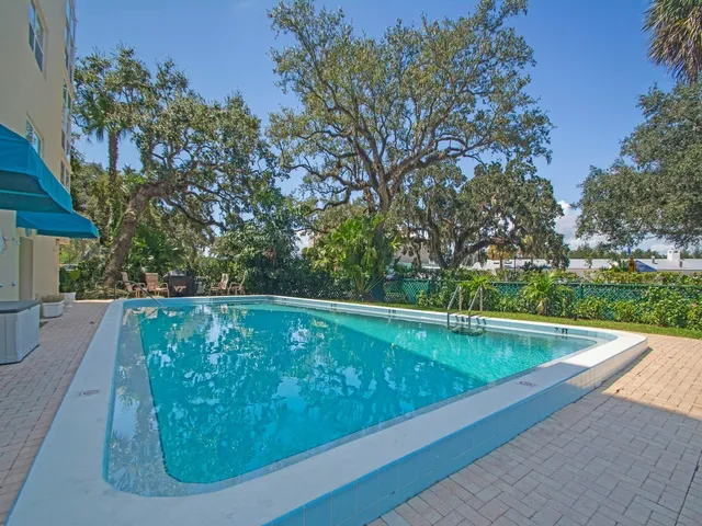 a view of a swimming pool with a yard