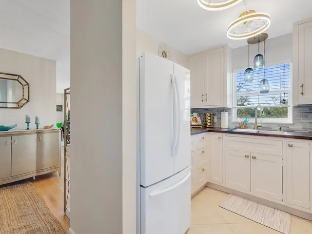 a kitchen with a refrigerator and a sink
