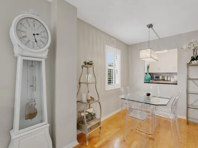 a living room with furniture a clock and a window