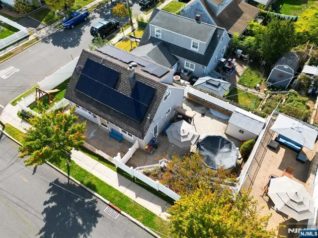 an aerial view of residential house with outdoor space and sitting area