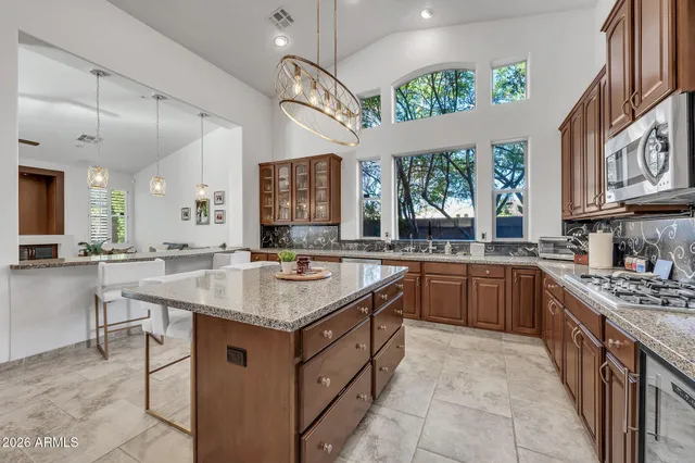 a kitchen with granite countertop a sink stove and cabinets