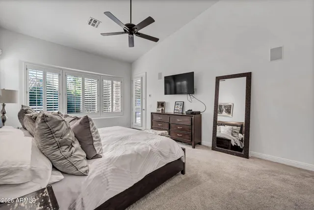 a bed room with a bed and a chandelier