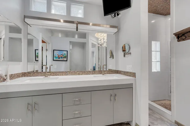 a view of a dining room with furniture a chandelier and wooden floor