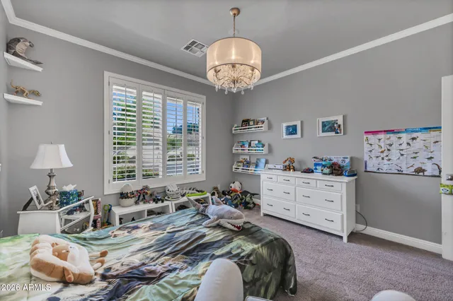 a bedroom with a bed a flat screen tv and dresser