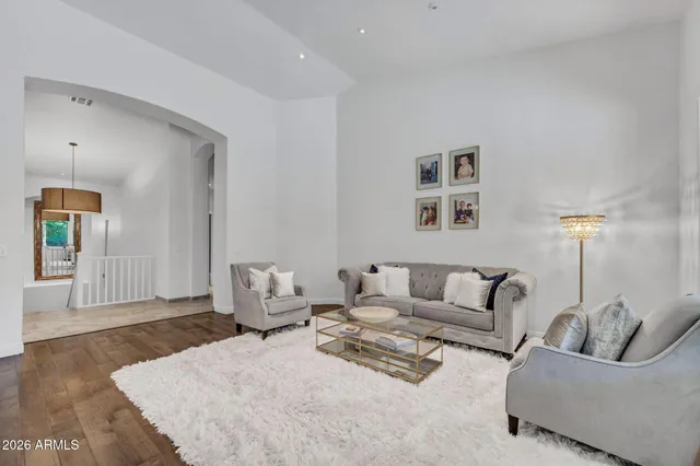 a living room with furniture a couch and kitchen view
