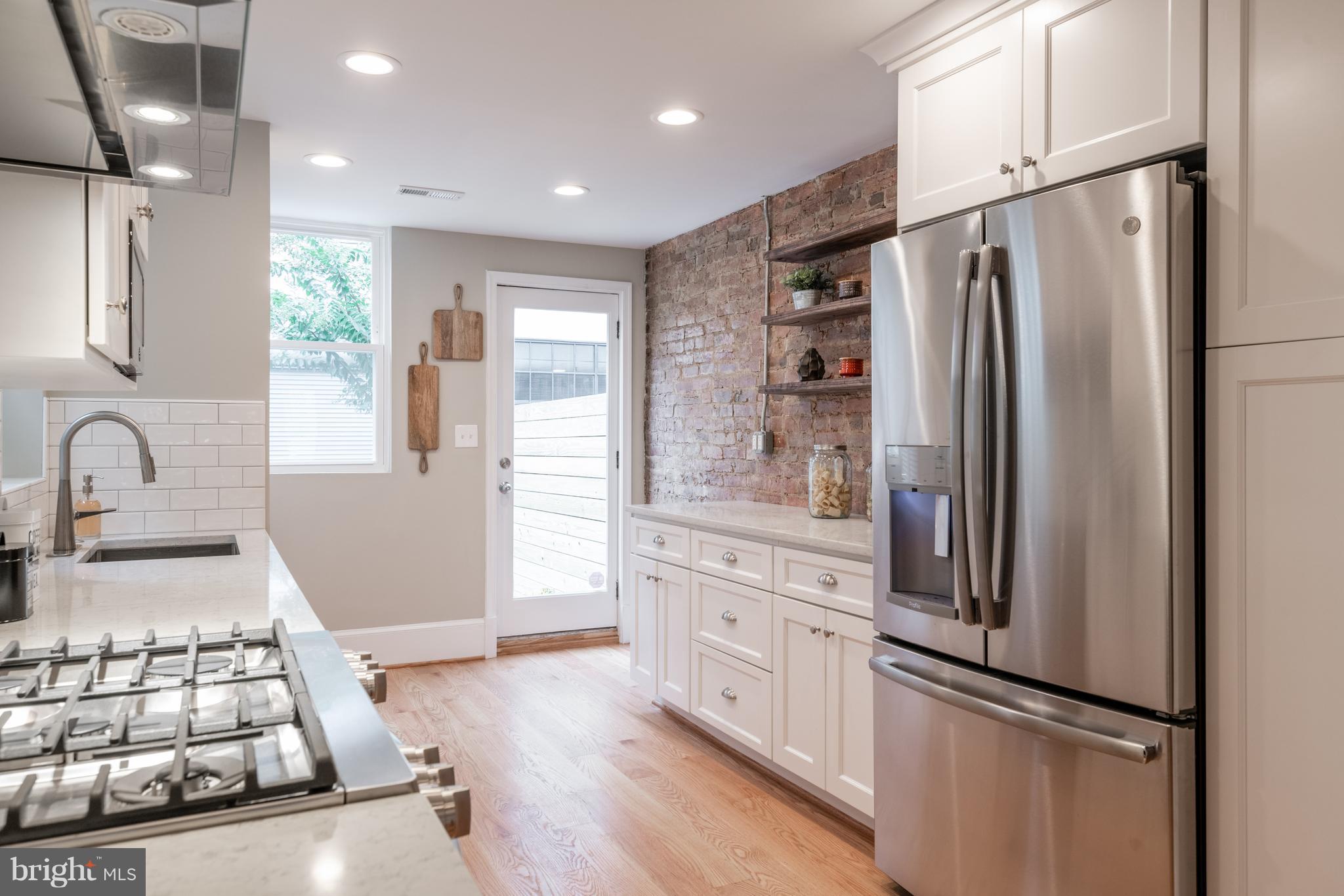 1327 V Street Northwest Washington, DC 20009 - Photo 11 of 29 a kitchen with stainless steel appliances granite countertop a refrigerator and a stove