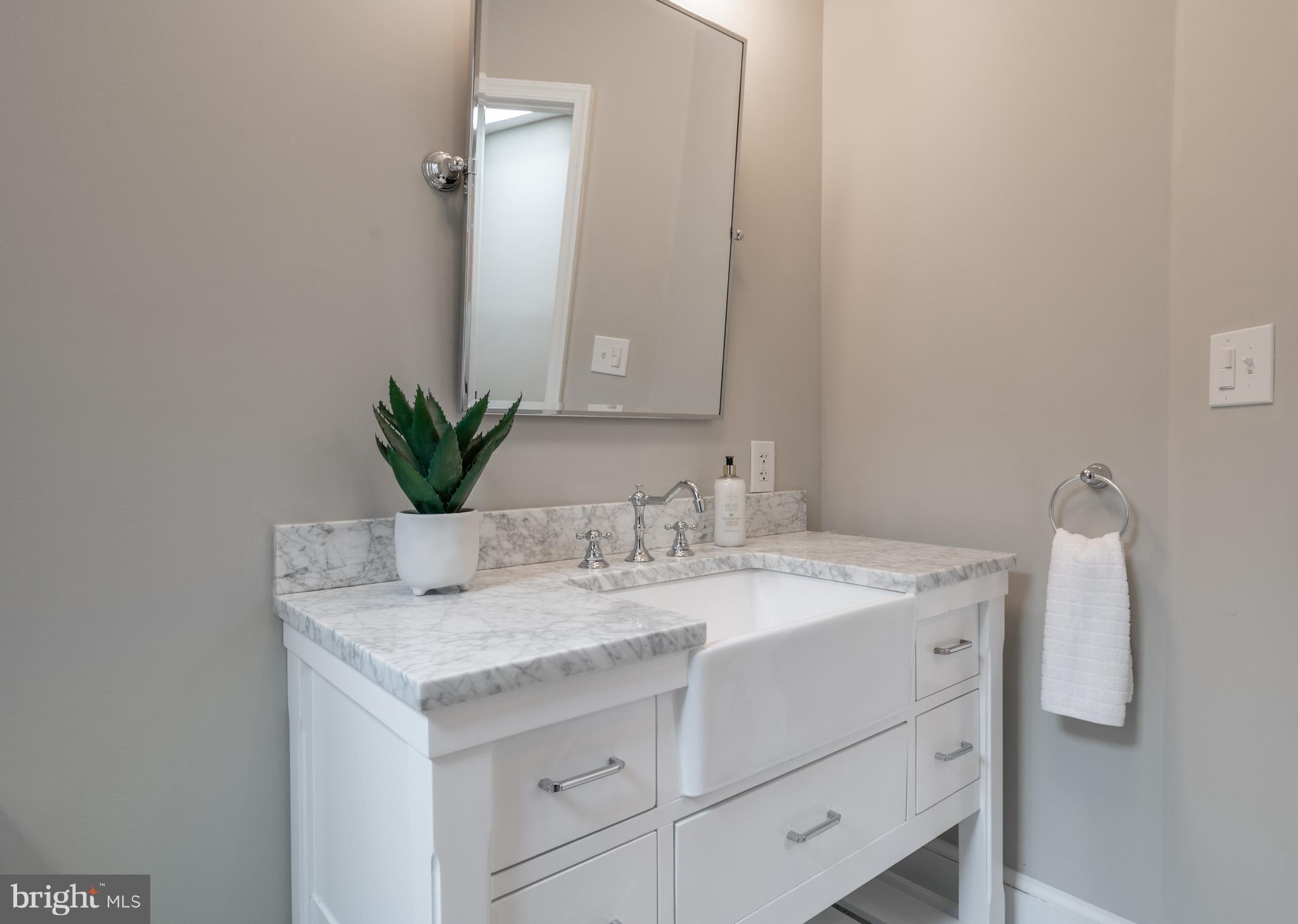 1327 V Street Northwest Washington, DC 20009 - Photo 21 of 29 a bathroom with a granite countertop sink and a mirror
