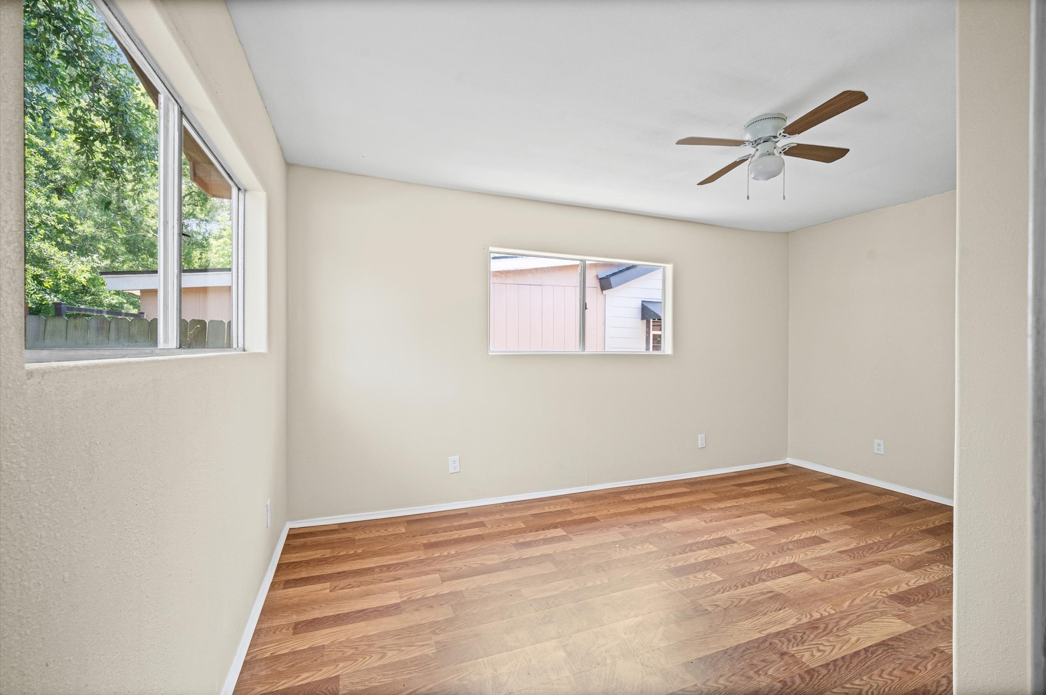 10621 Lane Street Houston, TX 77029 - Photo 18 of 29 a view of a big room with wooden floor and windows