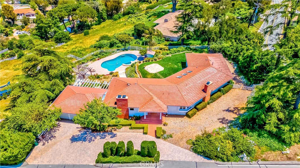 an aerial view of a house with a yard and garden
