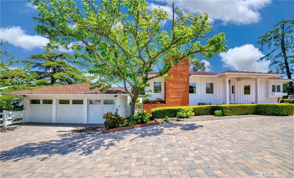 1 Hackamore Road Rolling Hills, CA 90274 - Photo 3 of 57 a front view of a house with a yard and potted plants
