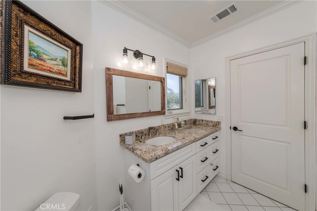 1 Hackamore Road Rolling Hills, CA 90274 - Photo 43 of 57 a bathroom with a granite countertop sink and a mirror