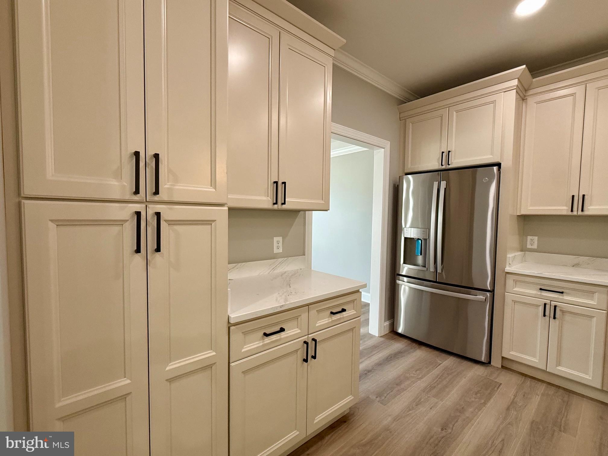 17480 Lighthouse Commons Drive Piney Point, MD 20674 - Photo 5 of 23 a kitchen with stainless steel appliances a refrigerator and cabinets