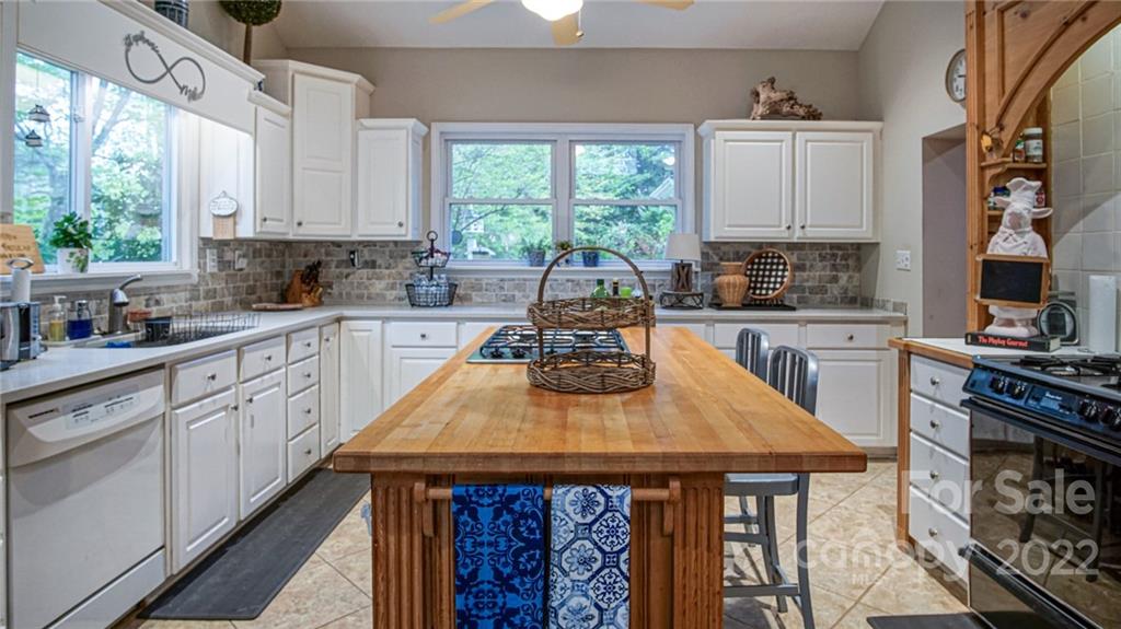 123 Grace Heights Rutherfordton, NC 28139 - Photo 20 of 48 a kitchen with a stove a sink dishwasher and cabinets with wooden floor