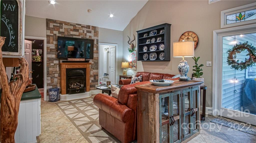 123 Grace Heights Rutherfordton, NC 28139 - Photo 24 of 48 a living room with furniture a fireplace and a potted plant