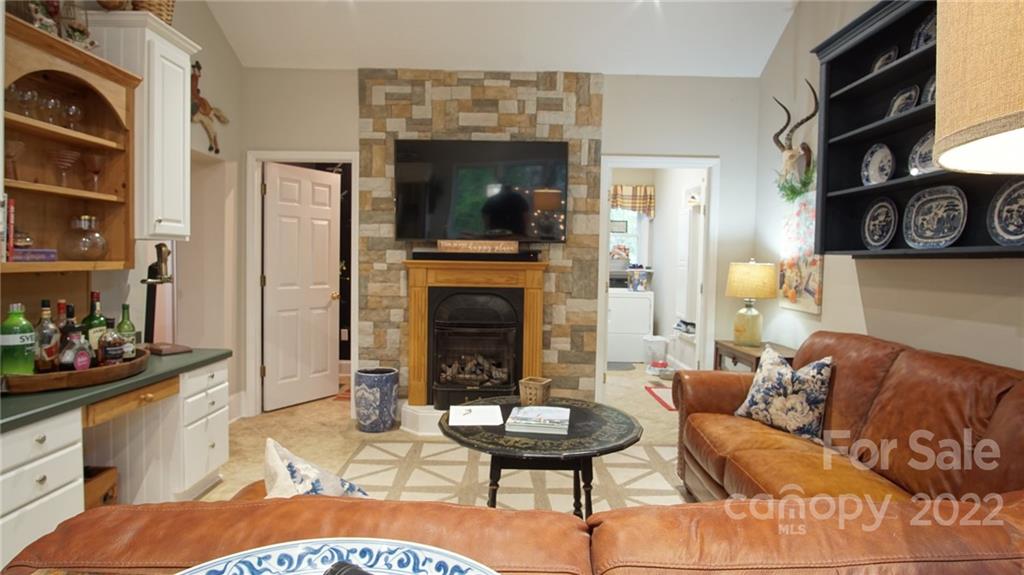 123 Grace Heights Rutherfordton, NC 28139 - Photo 25 of 48 a living room with furniture a flat screen tv and a fireplace