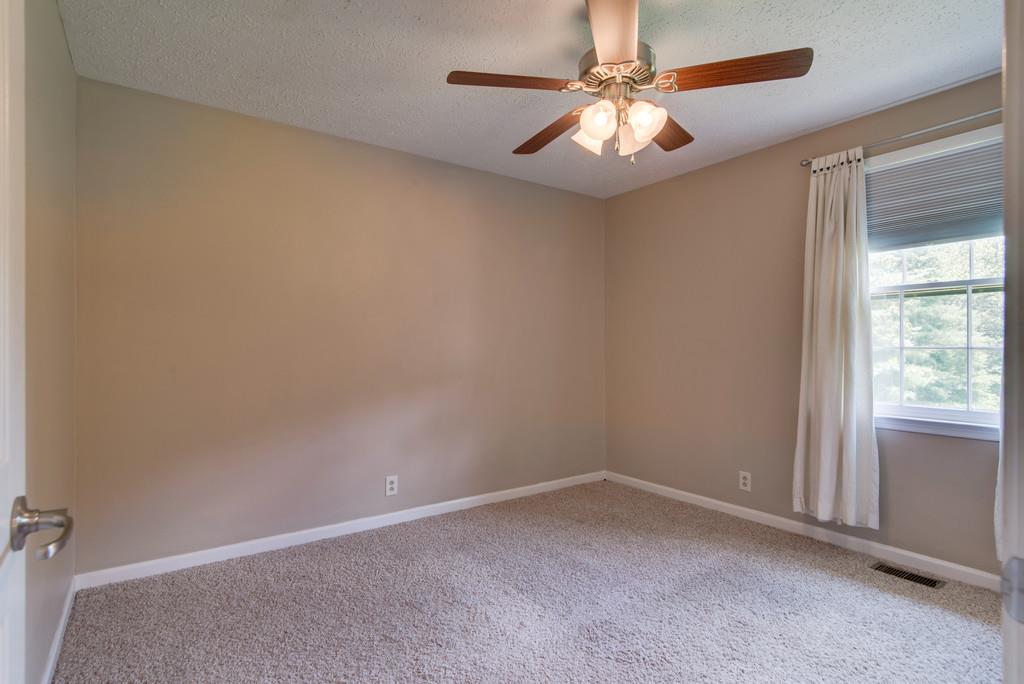 7810 Chester Road Fairview, TN 37062 - Photo 12 of 17 an empty room with a window and a fan