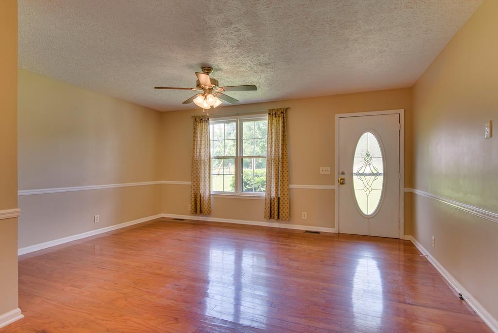 7810 Chester Road Fairview, TN 37062 - Photo 3 of 17 wooden floor in an empty room with a window
