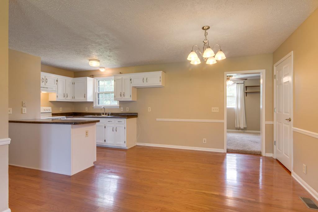 7810 Chester Road Fairview, TN 37062 - Photo 5 of 17 a kitchen with granite countertop white cabinets and stainless steel appliances