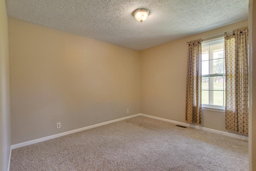 7810 Chester Road Fairview, TN 37062 - Photo 7 of 17 an empty room with a empty space and windows