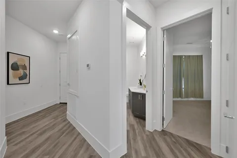 a view of hallway with wooden floor