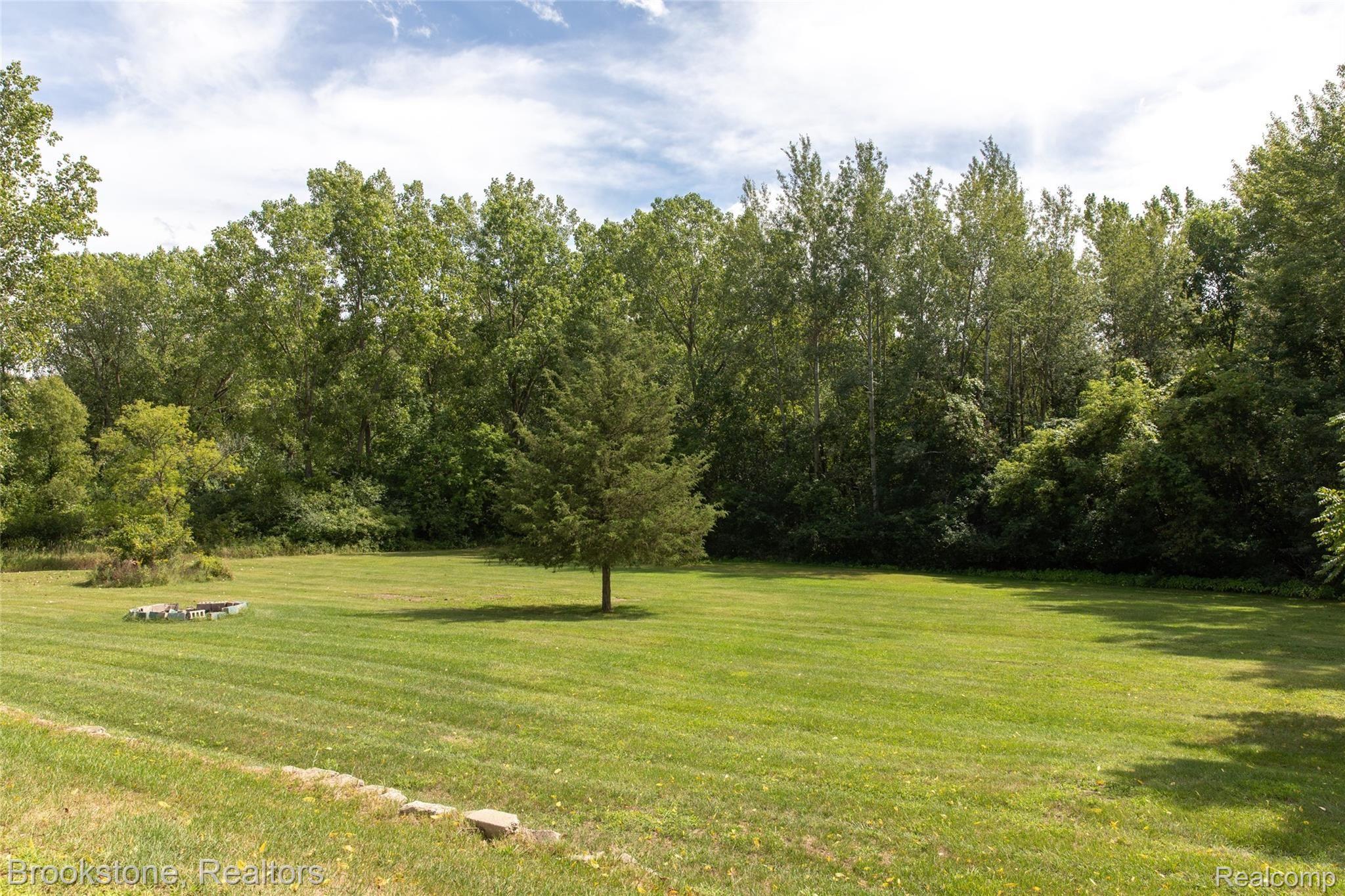 160 Collier Road Auburn Hills, MI 48326 - Photo 7 of 29 Trees surrounding backyard provide privacy