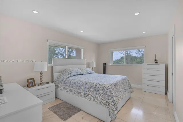 a bedroom with a large bed and dresser