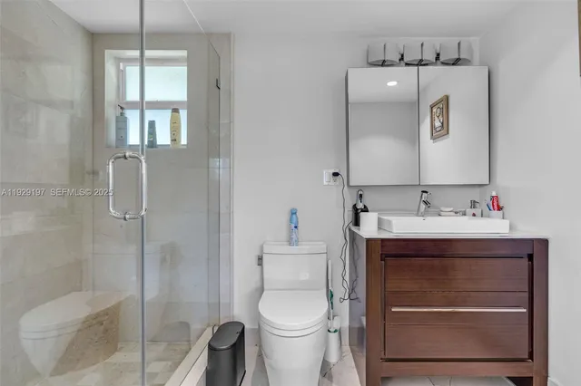 a bathroom with a sink vanity and toilet