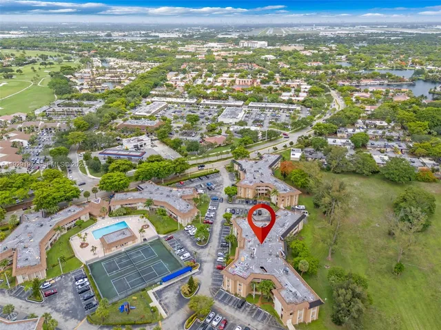 an aerial view of residential houses with outdoor space