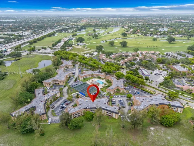 an aerial view of residential houses with outdoor space and river