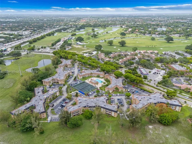 an aerial view of residential houses with outdoor space and swimming pool