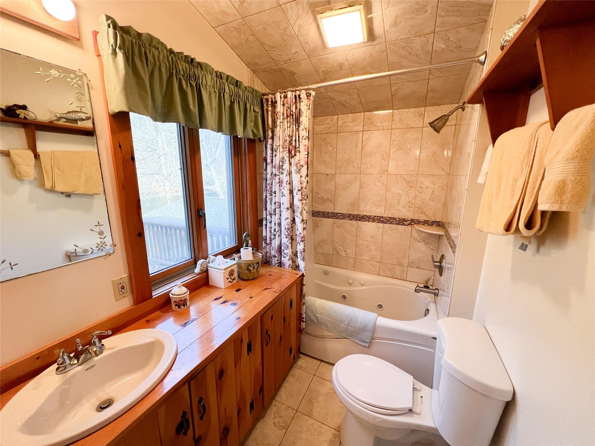 46 Beaverkill Mountain Road Roscoe, NY 12776 - Photo 15 of 27 a bathroom with a double vanity sink toilet and shower