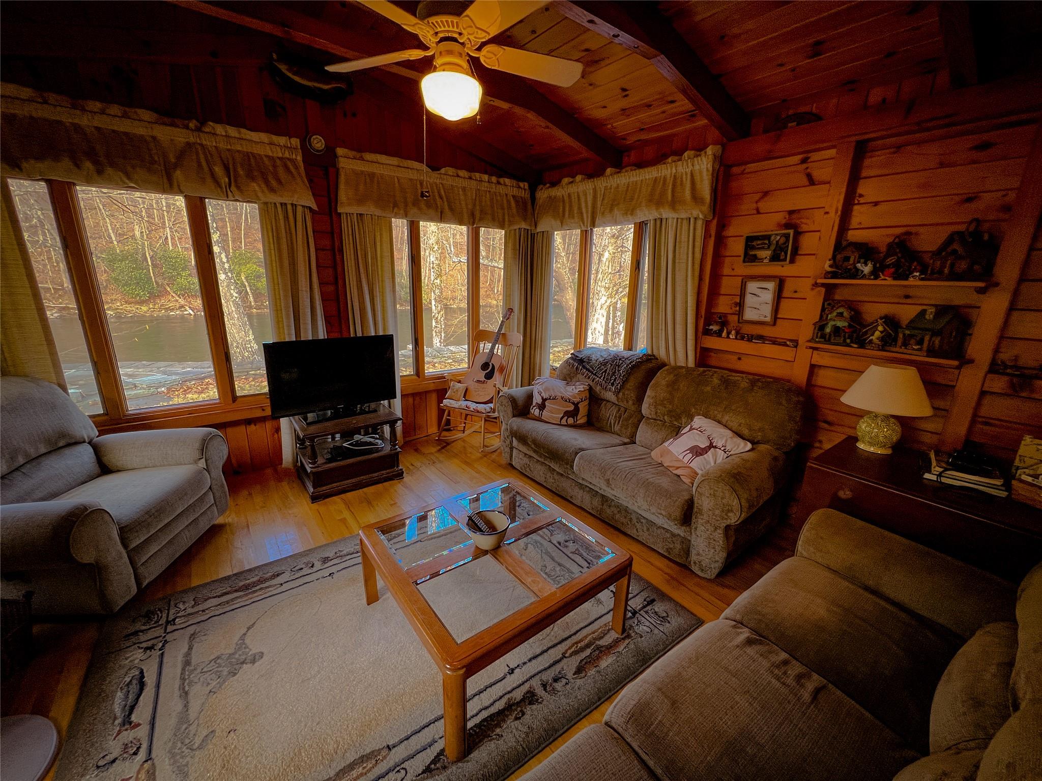 46 Beaverkill Mountain Road Roscoe, NY 12776 - Photo 24 of 27 a living room with furniture a flat screen tv and a window