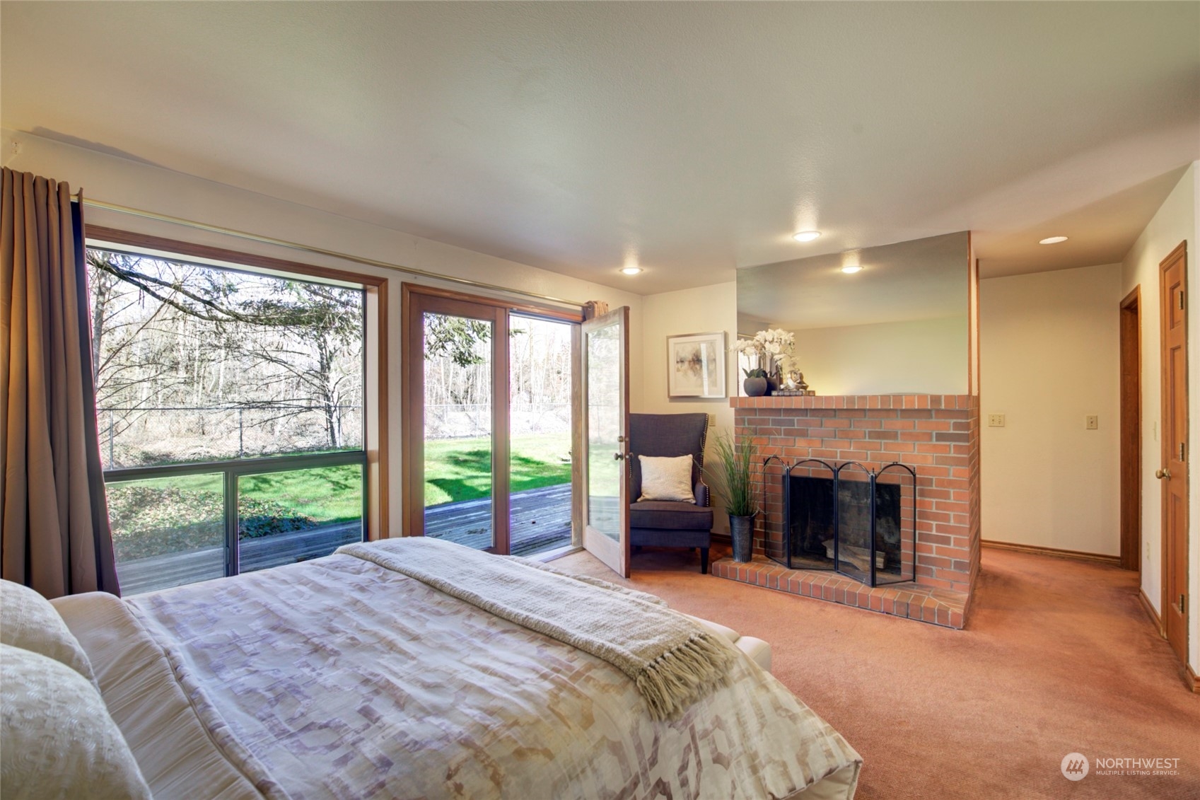 925 Riverside Drive Southeast North Bend, WA 98045 - Photo 15 of 30 a bedroom with a large bed and a fireplace