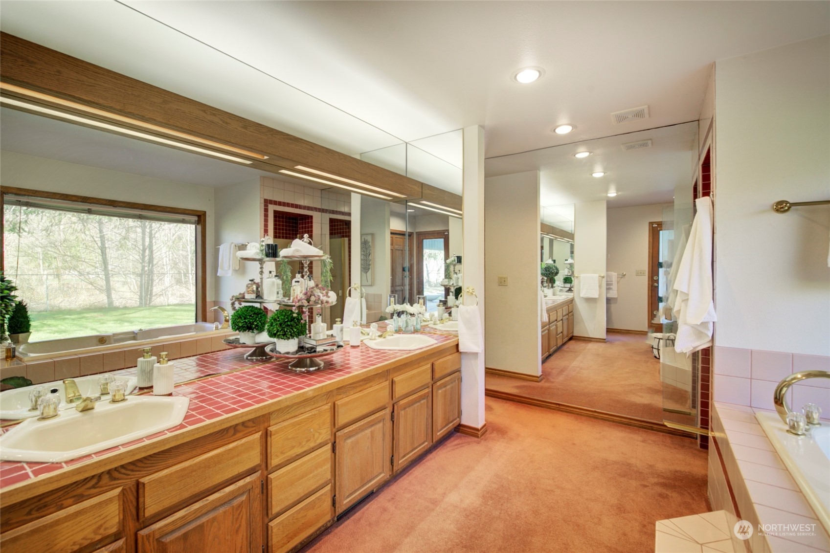925 Riverside Drive Southeast North Bend, WA 98045 - Photo 17 of 30 a bathroom with double vanity sinks a large mirror and a shower