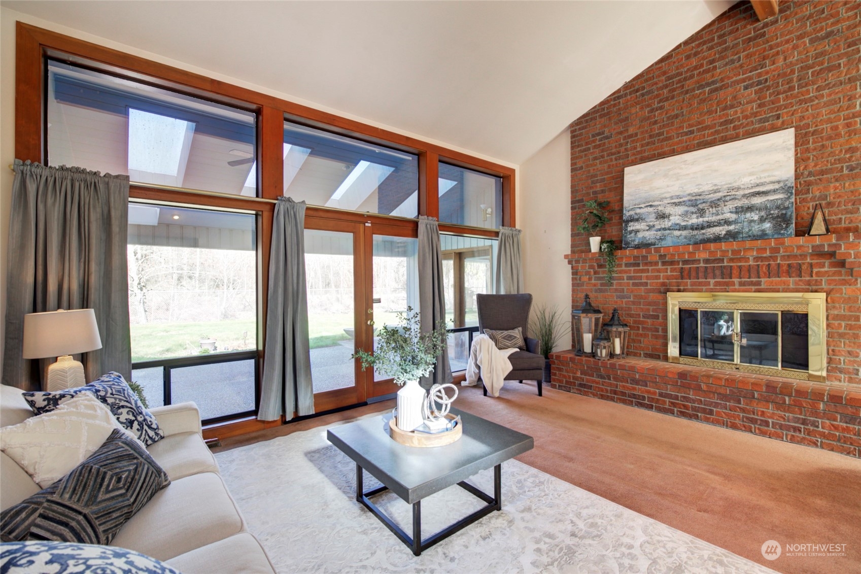 925 Riverside Drive Southeast North Bend, WA 98045 - Photo 5 of 30 a living room with furniture large window and a fireplace