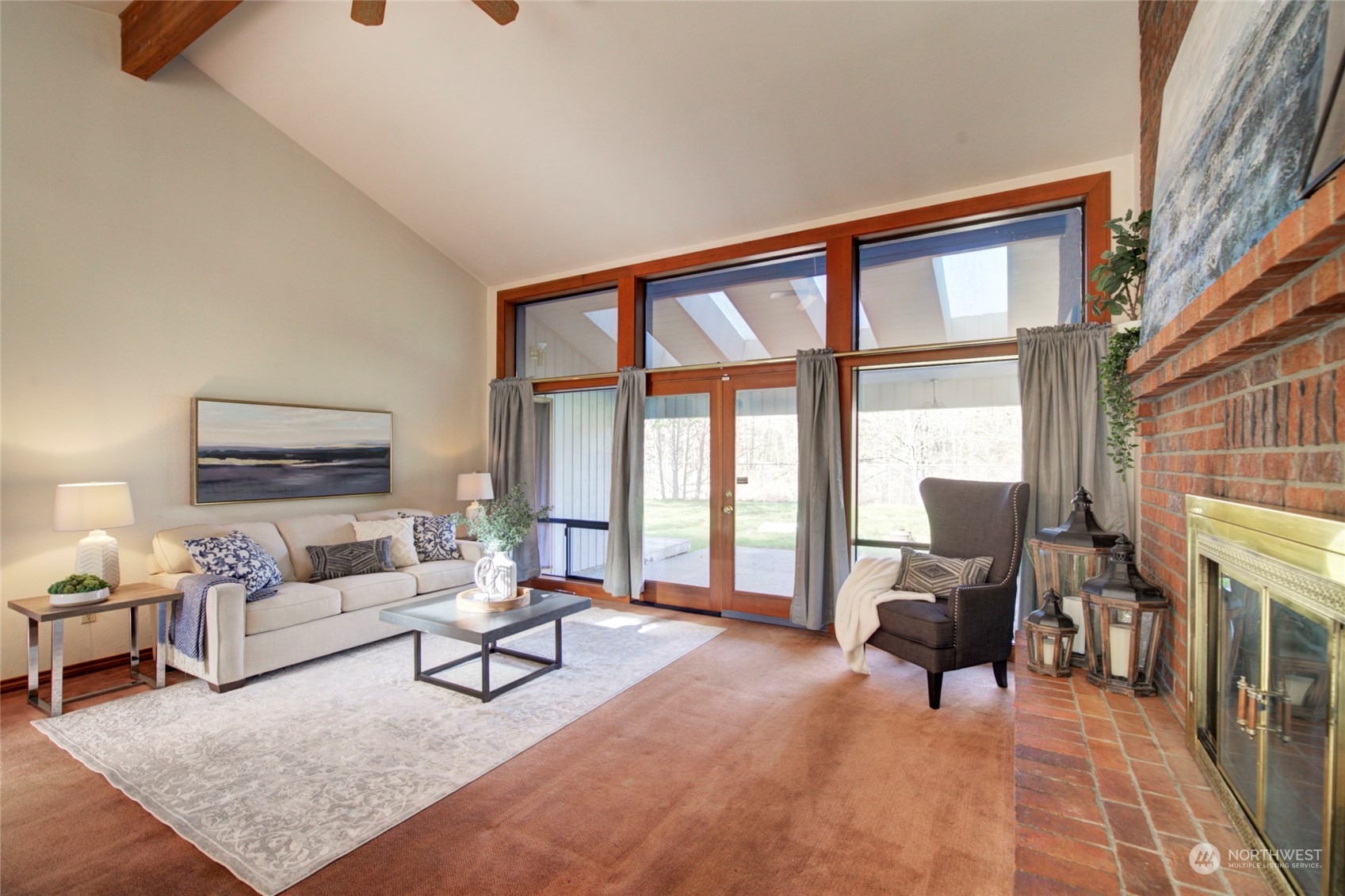 925 Riverside Drive Southeast North Bend, WA 98045 - Photo 6 of 30 a living room with furniture a rug and a floor to ceiling window