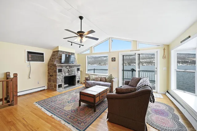 a living room with furniture a fireplace and a chandelier