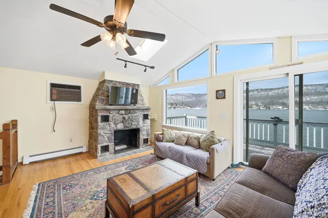 a living room with furniture a fireplace and a chandelier