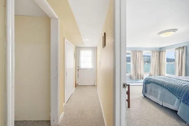 a view of a bedroom with bed and windows