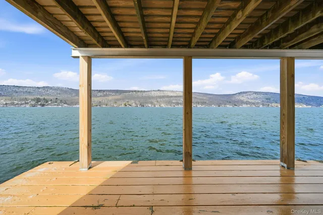 a view of a glass door with wooden floor and fence