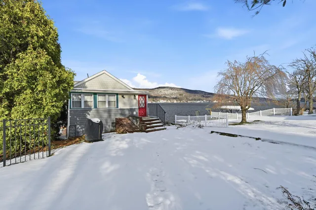 a view of a house with a yard and sitting area