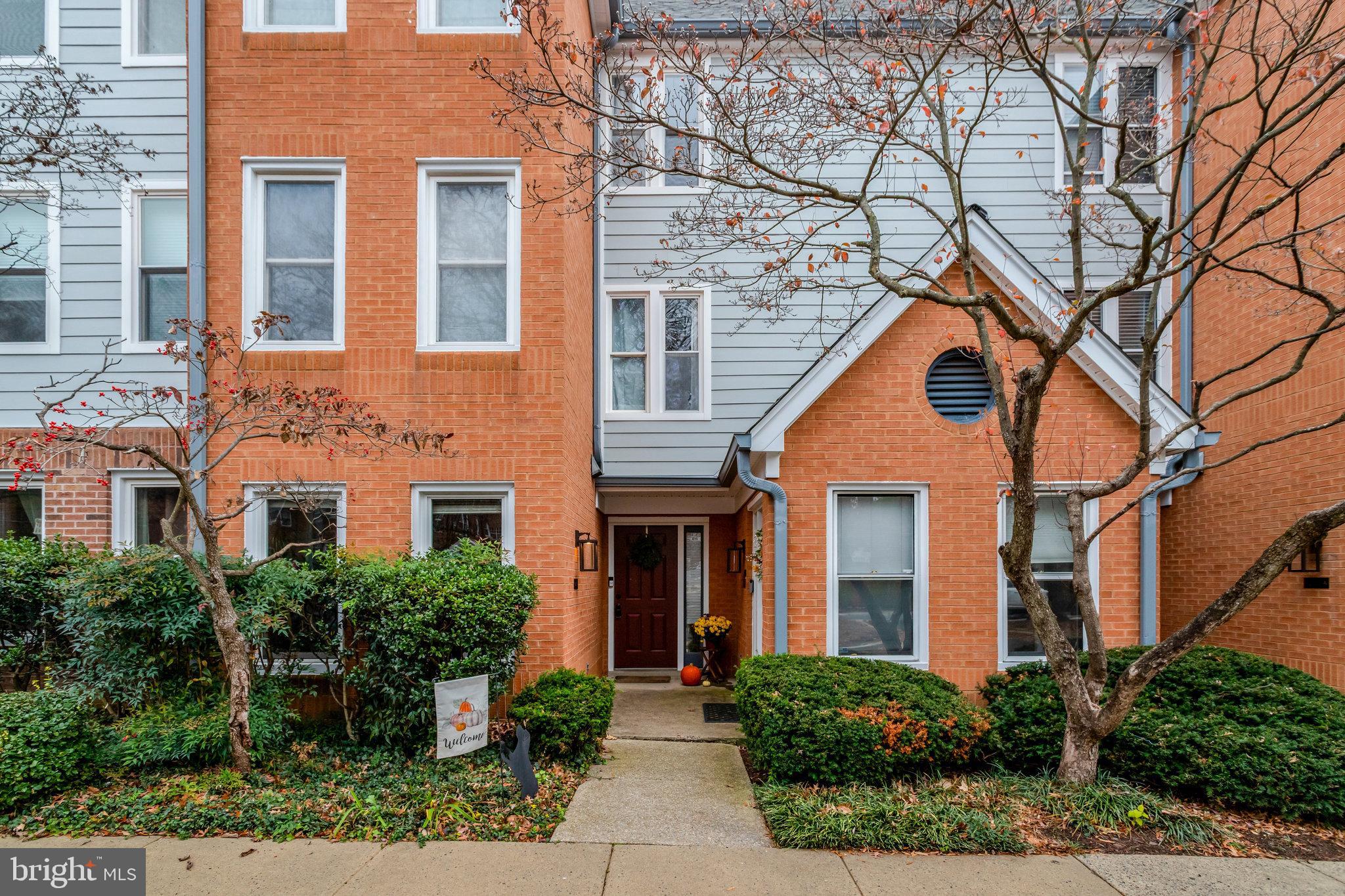 front view of a brick house with a small yard