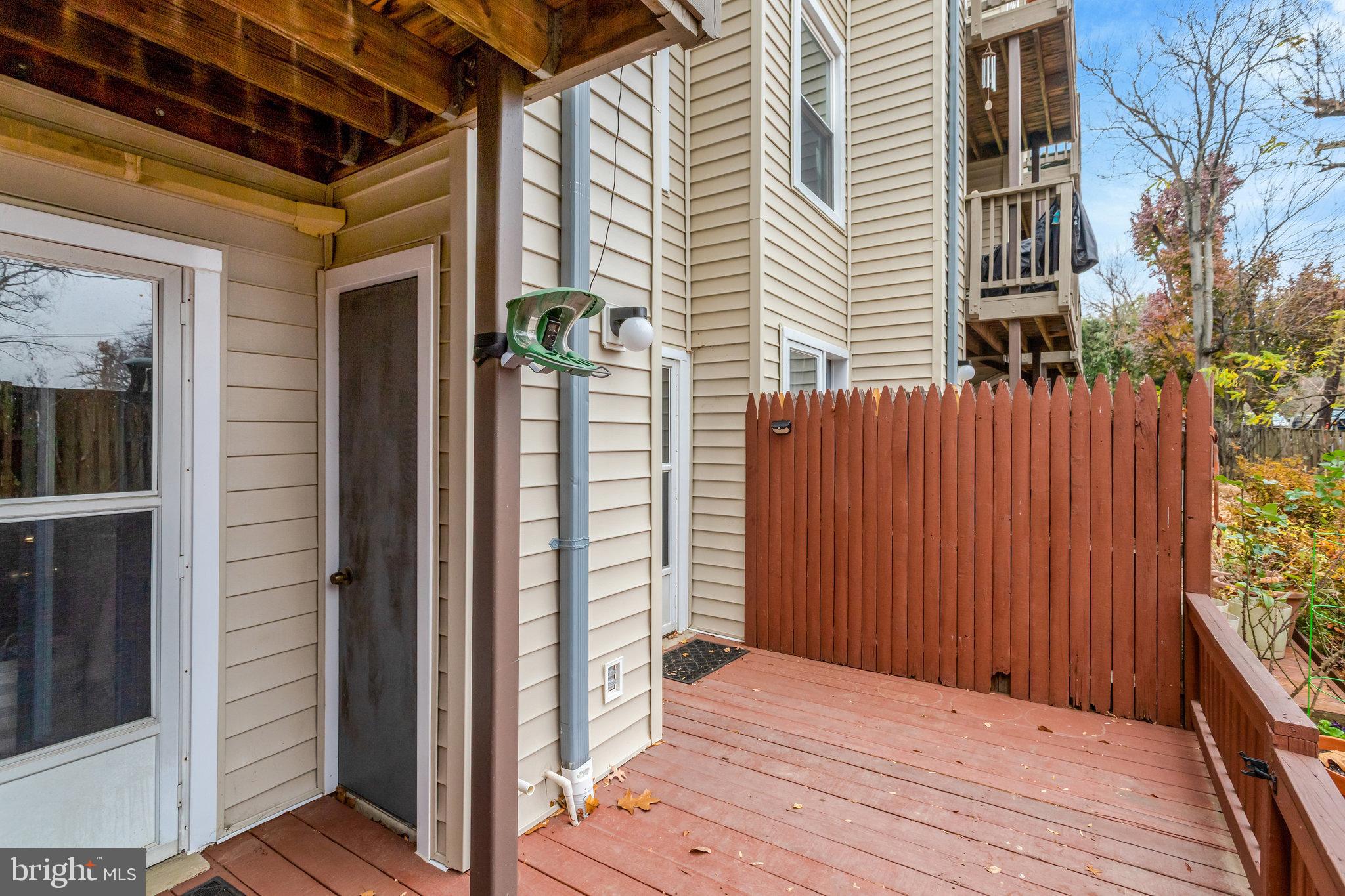 2101 North Rolfe Street, Unit C Arlington, VA 22209 - Photo 25 of 26 a view of backyard with wooden fence and large windows