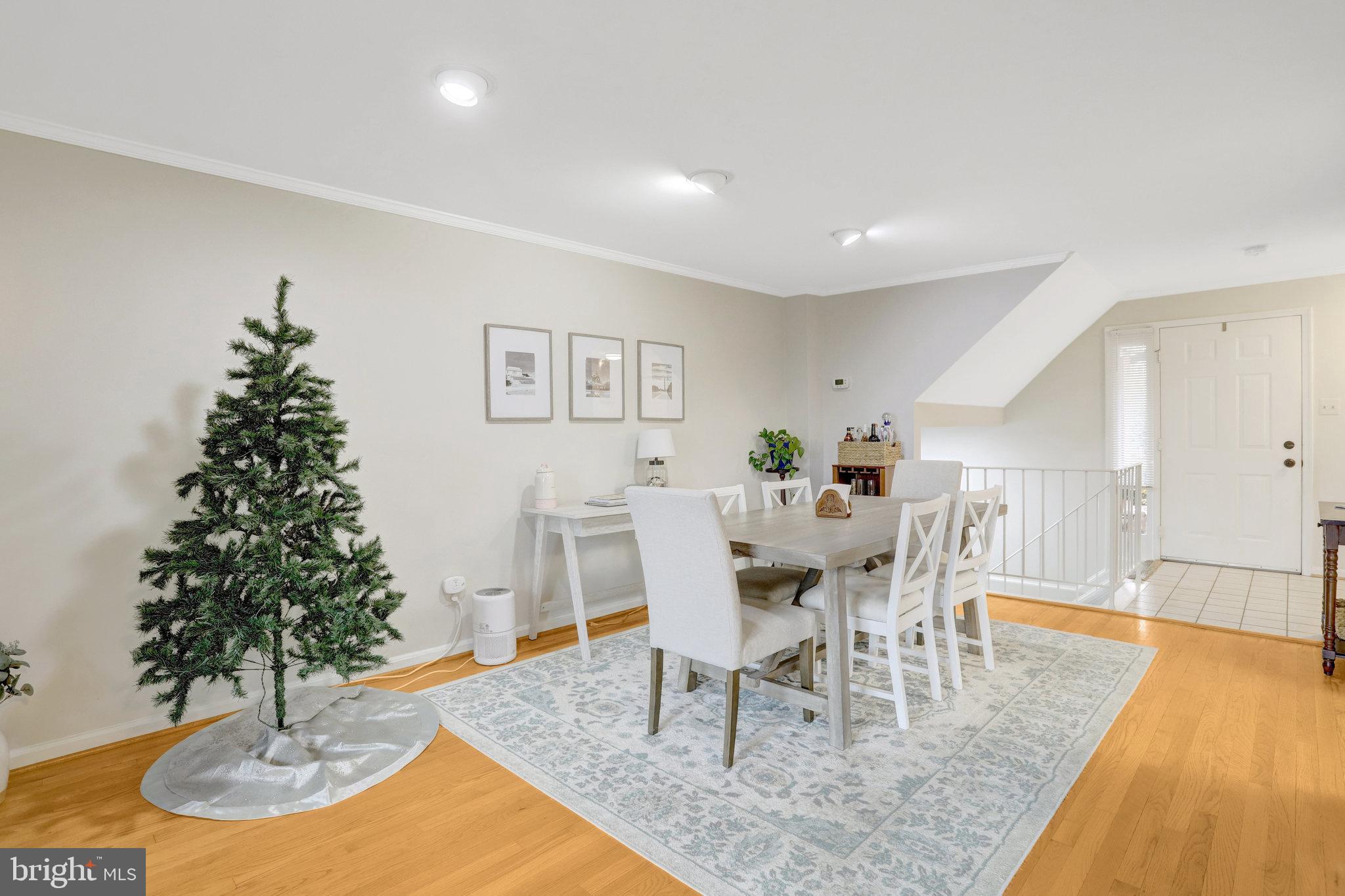 2101 North Rolfe Street, Unit C Arlington, VA 22209 - Photo 4 of 26 a view of a dining room with furniture and wooden floor