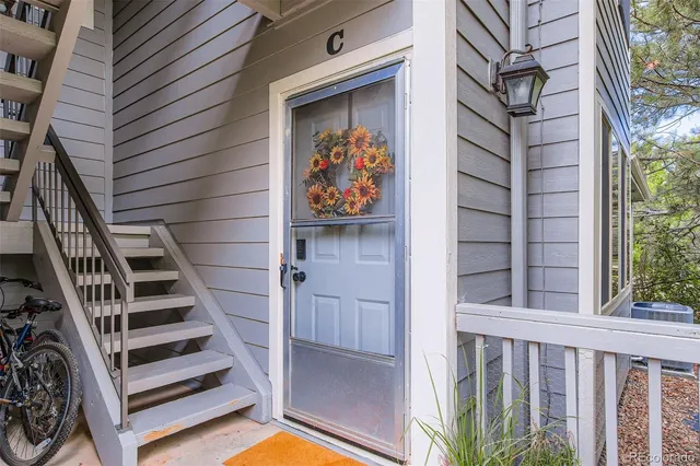 a view of entryway with wooden door and stairs
